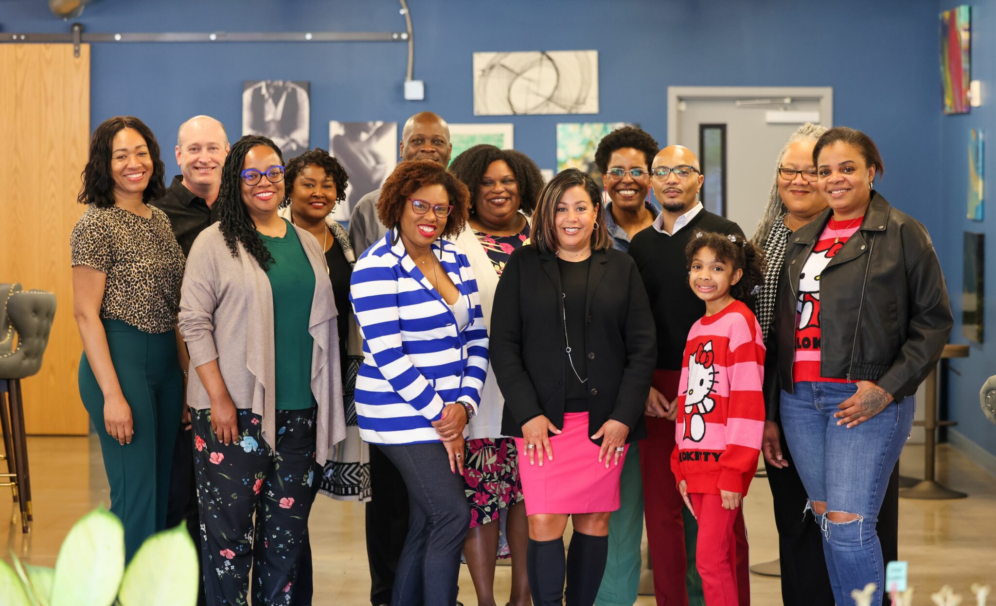 Group of 13 people posing for a picture