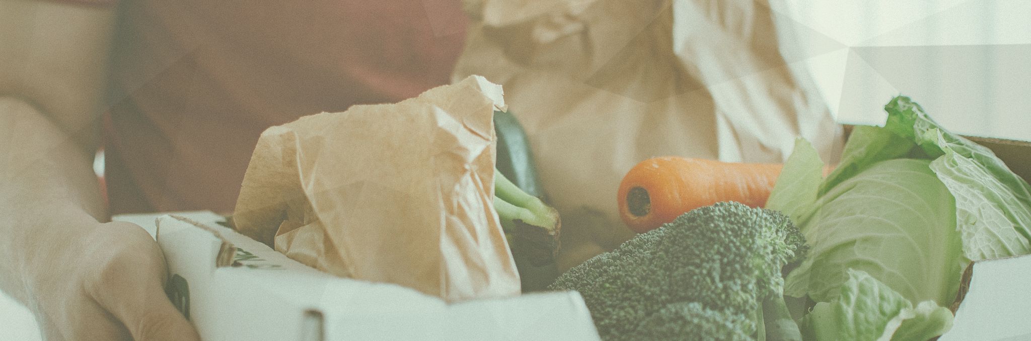 Food assistance, person carrying box of vegetables